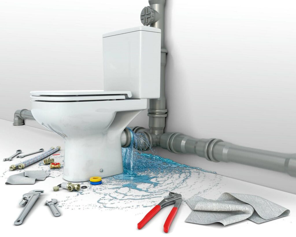 Toilet leaking water onto the floor with plumbing tools and parts scattered around.